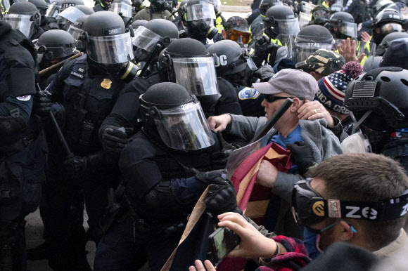 6일(현지시간) 미국 국회의사당 앞에서 경찰과 시위대가 충돌하고 있다. AP