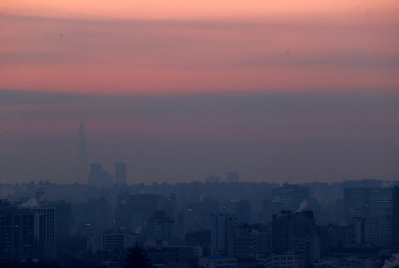 12일 오전 인왕산 자락에서 바라본 잠실 일대가 희미하게 보인다.  북극한파가 주춤한 이날 7시 현재 서울지역 초미세먼지 농도는 ‘나쁨’ 수준이다. 2021.1.12  연합뉴스