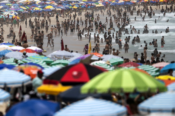 브라질에서 최근 코로나19가 급속히 재확산하는 가운데 24일(현지시간) 리우데자네이루의 이파네마 해변에 수천 명의 시민들이 모여 해수욕을 즐기고 있다. AP 연합뉴스