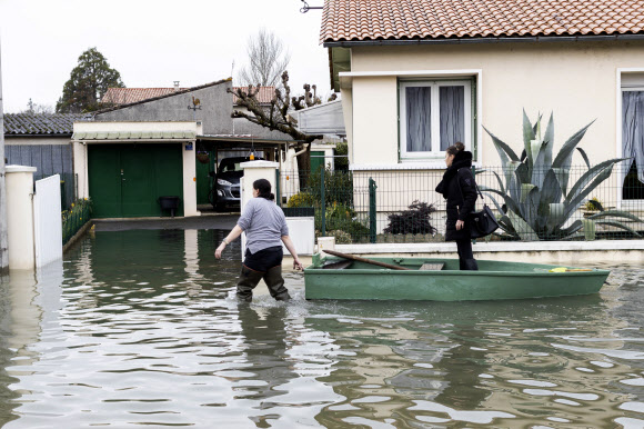 5일(현지시간) 프랑스 남서부 앙굴렘 인근 지역이 홍수로 물에 잠기자 주민이 보트를 끌고 있다. AP 연합뉴스