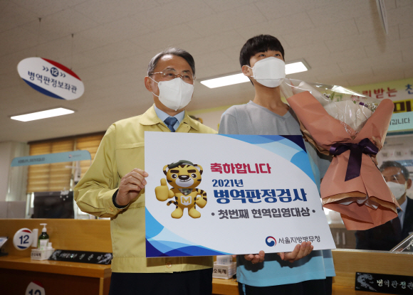 2021년도 첫 병역판정검사가 열린 17일 오전 영등포구 서울지방병무청 제1병역판정검사장에서 첫 현역입영대상자가 모종화 병무청장과 기념촬영을 하고 있다. 2021. 2. 17 정연호 기자 tpgod@seoul.co.kr