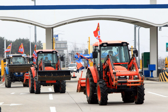 정부의 구상권 청구방침에 항의하는 트랙터 반납시위에 나선 강원 고상산불 이재민들이 22일 미시령톨게이트를 통과해 강원도청으로 향하고 있다. 이날 시위에 참여한 이재민은 15명으로 이들은 정부의 구상권 청구방침에 따라 농림축산식품부와 강원도로부터 지원을 받아 구매한 트랙터를 강원도에 현물로 반납하기로 했다. 2021.2.22  연합뉴스