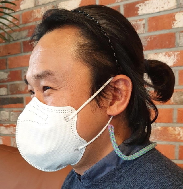 꽁지머리를 하고 있는 경남 김해시청 권오현 주무관. 한때 남자 공무원이 단정치 못하다는 오해를 받기도 했다. 권 주무관은 소아암환아를 돕기 위해 머리를 기르고 있다고 밝혔다. 뉴스1
