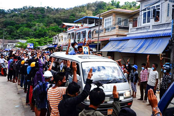 시위 사망자 장례행렬에 ‘세 손가락 경례’하는 미얀마 주민들