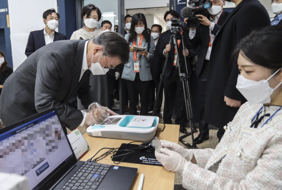 문재인 대통령과 부인 김정숙 여사가 2일 오전 서울 종로구 삼청동 주민센터를 방문해 2021재?보궐선거 사전투표를 했다. 문 대통령이 본인확인을 위해 서명하고 있다. 2021. 4. 2 청와대사진기자단