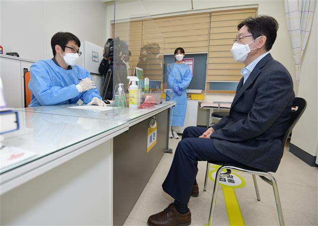 김경수 경남도지사가 5일 오전 창원보건소에서 코로나19 백신(아스트라제네카·AZ)을 접종하기 앞서 예진을 하고 있다. 김 지사는 예진표 작성과 예진, 접종, 이상반응 관찰 대기까지 모두 30분 정도 걸려 접종을 마쳤다. 2021.4.5 경남도 제공