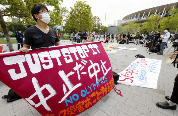 일본 시민들이 지난 9일 올림픽 경기장 근처에서 대회 개최를 중단하라는 시위를 하고 있다. 연합뉴스