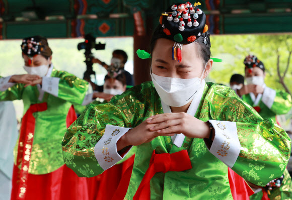 성년의 날인 17일 오전 서울 중구 남산골 한옥마을에서 열린 제49회 전통 성년례 재현행사에서 한 참석자가 초례를 마치고 큰절을 하며 자세를 낮추고 균형을 잡던 중 눈을 질끈 감고 있다. 2021.5.17  연합뉴스