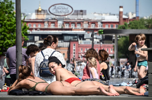 17일(현지시간) 러시아 모스크바에서 봄철 이상 고온 현상이 나타나자 시민들이 비키니 차림으로 일광욕을 즐기고 있다. AFP 연합뉴스