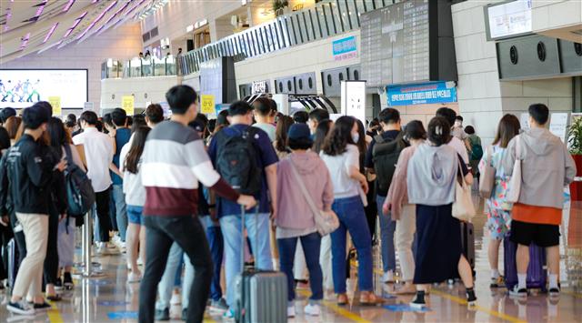 석가탄신일인 19일 오전 서울 강서구 김포국제공항 국내선 청사에서 여행객들이 체크인을 하기 위해 길게 줄 서 있다. 2021.5.19 뉴스1