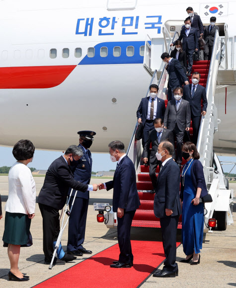 한미 정상회담에 참석하는 문재인 대통령이 19일(현지시간) 미국 워싱턴 앤드류스 공군기지에 도착, 환영 인사들과 악수하고 있다. 2021.5.20  연합뉴스