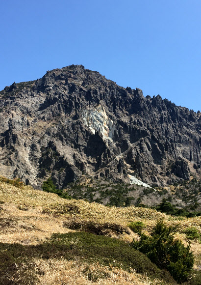 제주도 한라산 윗세오름 코스를 거쳐 남벽 분기점에 이르기 전에 보이는 해발 약 1천800m 높이의 백록담 남서쪽 암벽 일부가 무너져 내렸다고 31일 제주도 세계유산본부 한라산국립공원관리소 등이 밝혔다.  사진은 붕괴된 한라산 백록담 남서쪽 인근 절벽이 하얗게 보이는 모습. 2021.5.31 제주도 세계유산본부 한라산국립공원관리소 제공