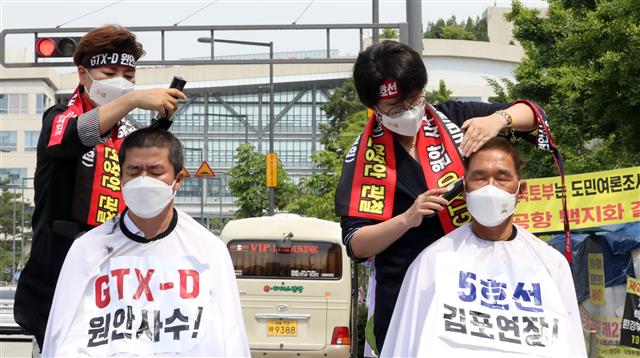 더불어민주당 박상혁(김포 을) 의원과 김주영 의원(김포 갑)이 2일 정부세종청사 국토교통부 앞에서 삭발 결의를 하며 ‘GTX-D노선 원안사수 및 서울 5호선 김포 연장’을 촉구하고 있다. 2021.6.2 뉴스1