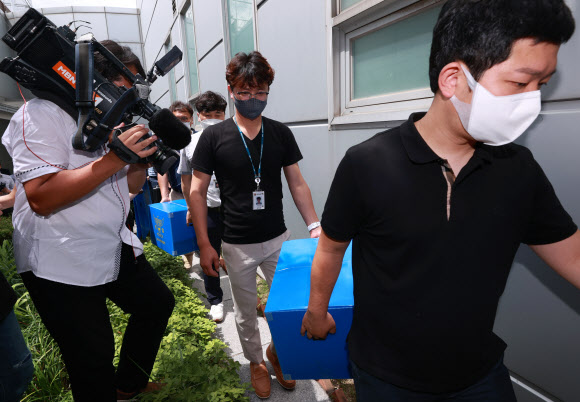 철거 중이던 건물 붕괴로 17명 사상 피해가 발생한 광주 학동 4구역 재개발사업을 수사 중인 경찰이 16일 서울 용산구 HDC현대산업개발 본사에 대한 압수수색을 마친 뒤 압수물이 든 박스와 함께 이동하고 있다. 2021.6.16  연합뉴스