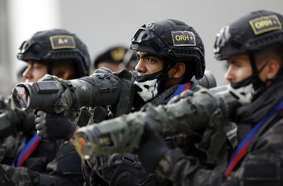 Soldiers march during the military parade marking the 200th anniversary of the battle of Carabobo in Valencia, Carabobo state, Venezuela, Thursday, June 24, 2021. The battle of Carabobo, on June 24, 1821, led by independence hero Simon Bolivar, was decisive in gaining Venezuela‘s independence from Spain. (AP Photo/Ariana Cubillos)