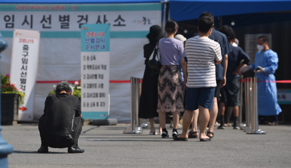 27일 서울역을 선별진료소를 찾은 한 시민이 기다림에 지쳐 앉아 있다.  2021.6.27 박지환기자 popocar@seoul.co.kr