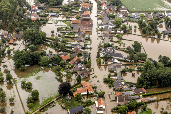 This aerial view taken in Brommelen on July 16, 2021 shows the flooded area around the Meuse after a levee of the Juliana Canal broke. - The death toll from devastating floods in Europe soared to at least 126 on July 16, 2021, most in western Germany where emergency responders were frantically searching for missing people. In Belgium, the government confirmed the death toll had jumped to 20 - earlier reports had said 23 dead - with more than 21,000 people left without electricity in one region. (Photo by Remko de Waal / ANP / AFP) / Netherlands OUT/2021-07-17 06:10:28/ <연합뉴스