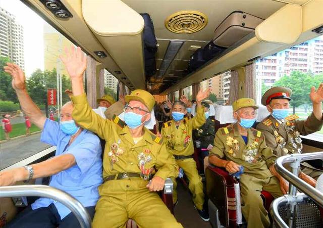 북한 노동당 기관지 노동신문은 26일 제7차 전국노병대회 참가자들이 전날 평양에 도착했다고 보도했다. 사진은 대회 참가자들이 자신들을 환영하는 평양 주민들에게 손 흔드는 모습. 평양 노동신문 뉴스1