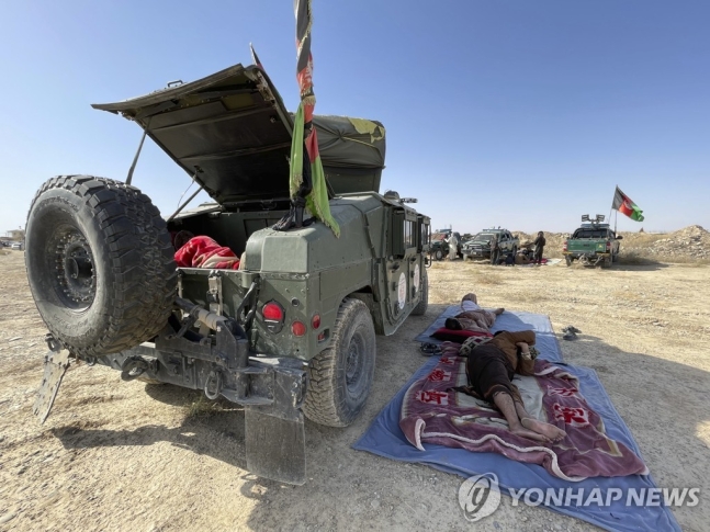 한 아프간 군인이 13일(현지시간) 칸다하르주에서 탈레반과 전투 중에 휴식을 취하고 있다. AP 연합뉴스