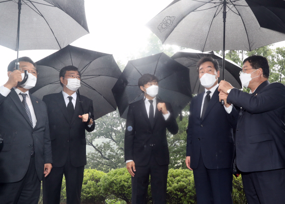 더불어민주당 이낙연 경선 후보가 김대중 전 대통령 서거 12주기인 18일 서울 동작구 국립서울현충원 김 전 대통령 묘역을 참배한 뒤 유족인 차남인 김홍업 김대중 평화센터 이사장 등과 대화하고 있다.  2021. 8. 18 김명국 선임기자 daunso@seoul.co.kr