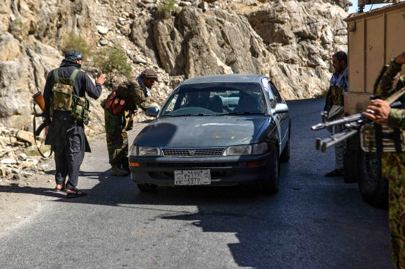 아프가니스탄 반 탈레반 저항군들이 25일(현지시간) 아프간 북부 판지시르주의 라에탕 지구 도로에서 차량을 검문하고 있다. AFP 연합뉴스