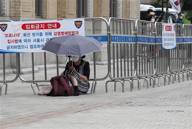 사랑제일교회 신도 등이 29일 오전 서울 광화문 일대에서 온라인을 통해 생중계되는 주일예배를 시청하고 있다..  한편 사랑제일교회는 성북구청의 시설폐쇄 명령이 이뤄진 지난 19일 이후 첫 주말인 22일 교회를 폐쇄한 대신 서울역과 서울시청, 광화문 일대에서 경찰 추산 800여명 규모의 야외예배를 진행했었고, 서울시는 전광훈 목사 등 교회 관계자 4명을 방역지침 위반으로 서울경찰청에 고발했다. 2021.8.29 뉴스1