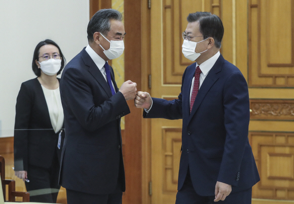 문재인 대통령이 15일 청와대에서 왕이 중국 외교부장을 접견했다. 문 대통령이 접견장에 입장하며 왕이 중국 외교부장과 주먹인사하고 있다. 2021. 9. 15 도준석 기자 pado@seoul.co.kr