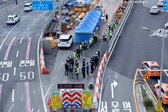 추석 연휴가 끝나자마자 신종 코로나바이러스 감염증(코로나19) 신규 확진자 수가 폭증하면서 최다치를 기록한 24일 오전 서울역 광장 인근 공사장에 마련된 서울시 찾아가는 선별진료소에서 공사장 관계자들이 검사를 받기 위해 기다리고 있다.  중앙방역대책본부(방대본)는 이날 0시 기준으로 신규 확진자가 2천434명 늘어 누적 29만5천132명이라고 밝혔다.  지난달 11일 2천221명 이후 44일 만에 최다 기록을 경신했다. 2021.9.24  연합뉴스