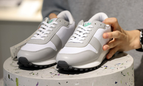 6일 서울 성동구 LAR 매장에서 직원이 폐페트병 소재로 만든 운동화를 선보이고 있다. 이 운동화는 롯데케미칼 주관으로 7개 업체가 참여한 플라스틱 자원선순환 프로젝트인 ‘프로젝트 루프’(Project LOOP)를 통해 제작된 제품으로, 신동빈 롯데그룹 회장이 평소 자주 신는 것으로 알려졌다. 2021.10.6  연합뉴스