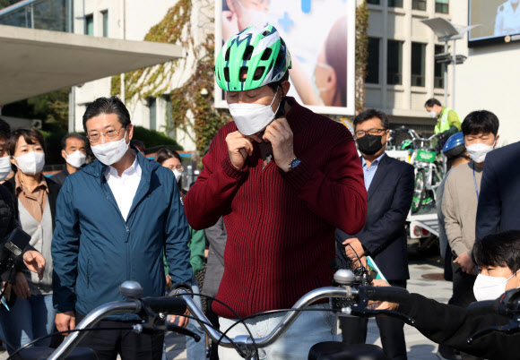 오세훈 서울시장이 22일 오전 서울 중구 도시건축전시관 앞 ‘따릉이’ 자전거대여소에서 자전거 대여 후 헬멧을 착용하고 있다. 2021.10.22  연합뉴스