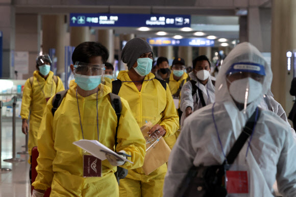 29일 오전 방역복을 입은 해외 입국자들이 인천국제공항을 통해 입국하고 있다.  방역 당국은은 새로운 코로나19 변이 바이러스인 ‘오미크론’의 국내 유입 차단을 위해 남아프리카 8개국에서 오는 외국인을 입국금지 조처했으며, 향후 대상 국가를 확대하는 방안을 검토할 방침이다. 2021.11.29  연합뉴스