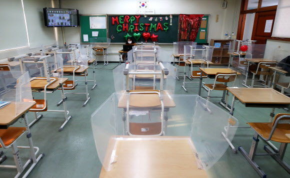 수도권 모든 학교의 전면등교가 중단되고 등교수업과 원격수업이 병행 실시된 20일 오전 경기도 수원시 화홍중학교 3학년 교실에서 선생님이 원격수업을 하고 있다. 2021.12.20 연합뉴스