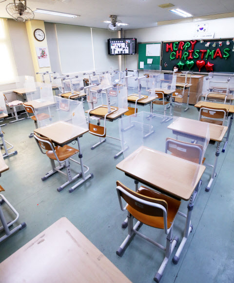 수도권 모든 학교의 전면등교가 중단되고 등교수업과 원격수업이 병행 실시된 20일 오전 경기도 수원시 화홍중학교 3학년 교실에서 선생님이 원격수업을 하고 있다. 2021.12.20 연합뉴스