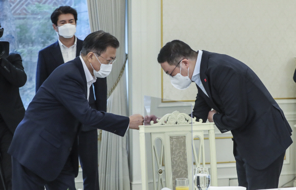 문재인 대통령이 27일 청와대에서 정부의 민관합동 청년 일자리 창출 사업인 ‘청년희망온(ON)’에 참여한 대기업 대표들과 오찬 간담회를 가졌다. 문 대통령이 간담회에 앞서 구광모 LG 회장과 인사하고 있다. 2021. 12. 27. 도준석 기자 pado@seoul.co.kr