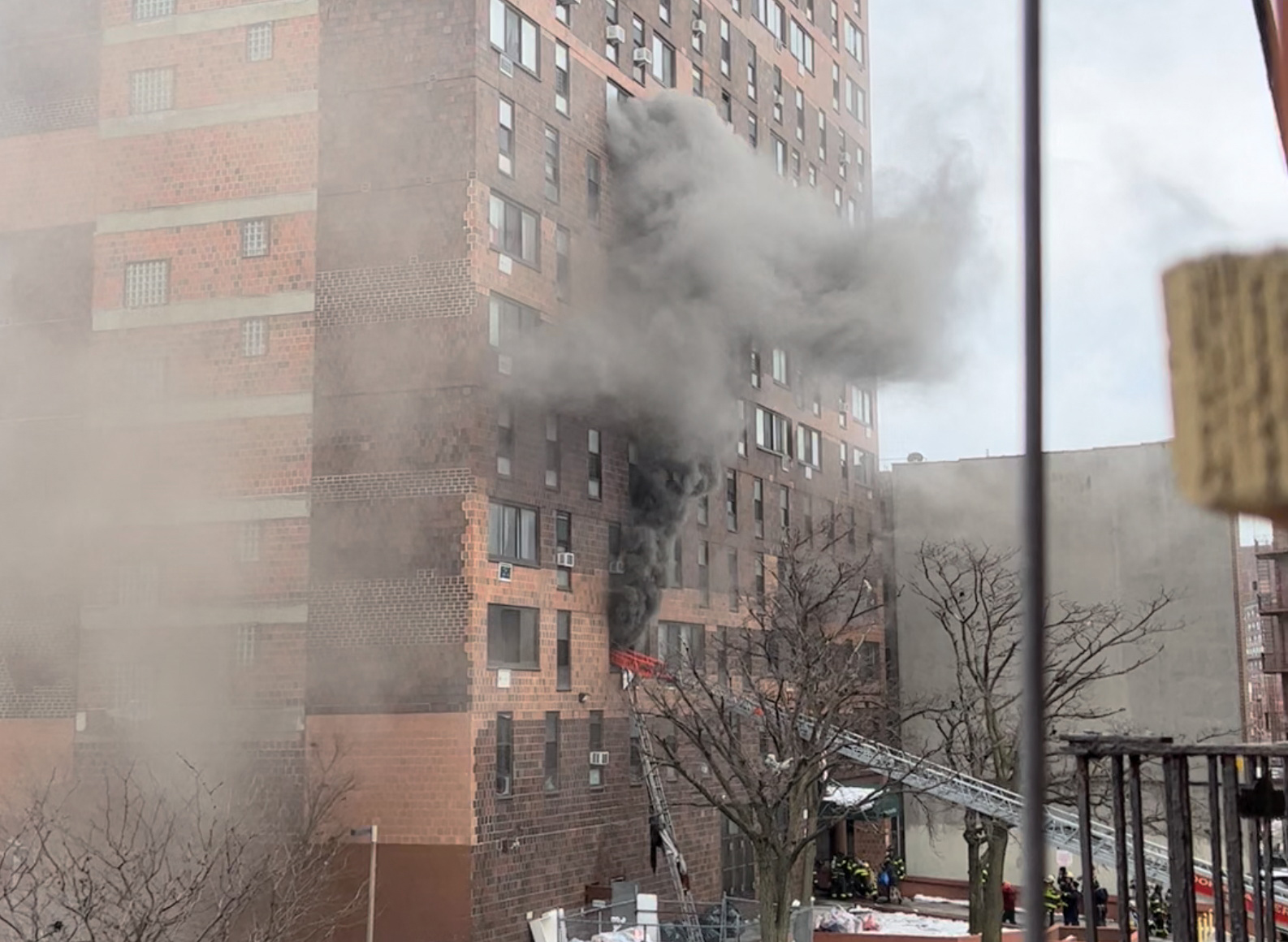 9일(현지시간) 미국 뉴욕 브롱크스의 19층짜리 아파트에서 화재가 발생한 가운데 소방대원들이 치솟는 연기 속에서 생존자 구조작업을 벌이고 있다. 로이터 연합뉴스