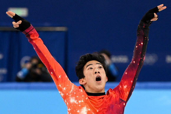 U네이선 첸이 10일 베이징동계올림픽 피겨스케이팅 남자 싱글 프리스케이팅 연기를 모두 마친 뒤 두 팔을 들어올리며 금메달을 확신한 듯한 표정을 짓고 있다. [AFP 연합뉴스]