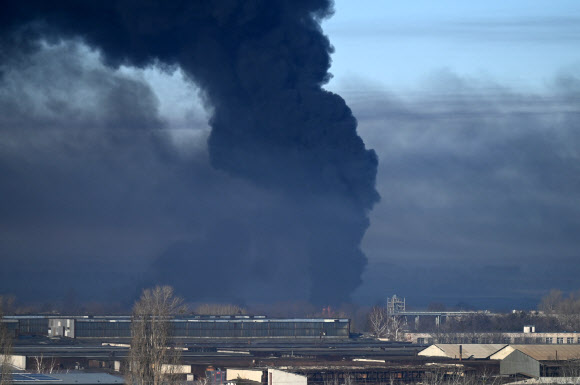 24일(현지시간) 우크라이나 추구예프 공군기지가 러시아의 공격을 받아 검은 화염이 치솟고 있다. AFP 연합뉴스
