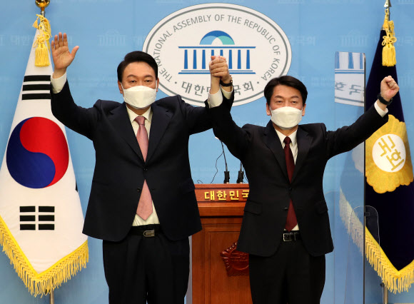 국민의힘 윤석열 대선 후보와 국민의당 안철수 대선 후보가 3일 오전 국회 소통관에서 단일화 기자회견을 마치며 포즈를 취하고 있다. 2022.3.3  국회사진기자단