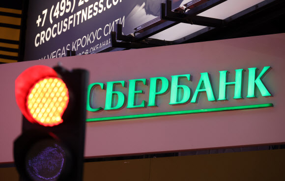 러시아의 우크라이나 침공 직후 미국이 러시아 주요 은행들에 대한 제재 방침을 밝힌 지난달 24일(현지시간) 러시아 최대 민간은행인 스베르방크의 한 모스크바 지점 앞에 빨간 신호등이 켜져 있다. 모스크바 타스 연합뉴스