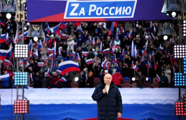 블라디미르 푸틴 러시아 대통령이 18일(현지시간) 모스크바에서 열린 크름반도 합병 8주년 콘서트에서 무대 연설을 하고 있다. 모스크바 로이터 연합뉴스