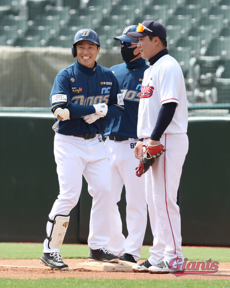 손아섭(왼쪽·NC)이 21일 부산 사직구장에서 열린 롯데전에서 시범경기 첫 안타를 신고한 뒤 1루에서 웃고 있다. 롯데 자이언츠 제공