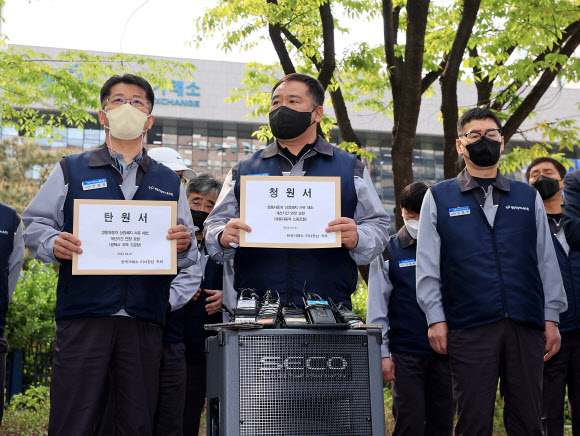 선목래(가운데) 쌍용차 노조위원장이 21일 서울 여의도 한국거래소 앞에서 회사의 상장 폐지 기간 연장을 호소하고 있다. 연합뉴스