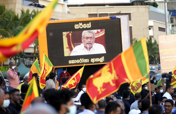 스리랑카 수도 콜롬보에서 시위대가 고타바야 라자팍사 대통령 가족의 사임을 요구하는 시위를 벌이고 있는 가운데 라자팍사 대통령의 연설이 전광판을 통해 방송되고 있다. 2022.4.29 AP 연합뉴스