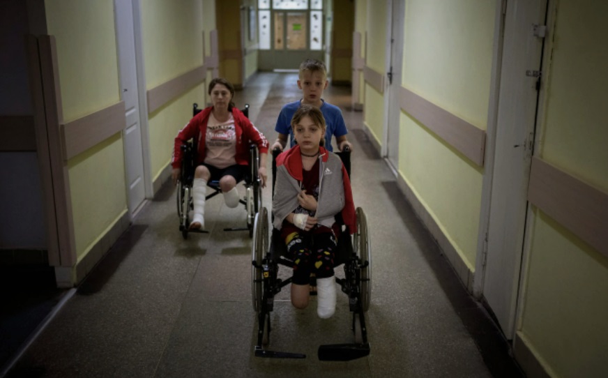 다리가 절단된 11세 쌍둥이 자매들이 휠체어에 앉아 이동하고 있다. 에밀리오 모레나티 AP통신 사진기자 제공