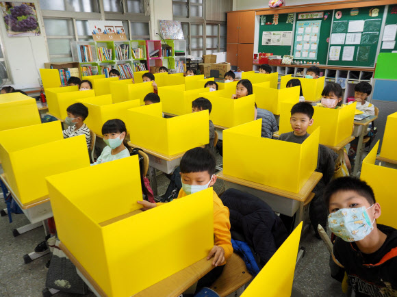 2020년 3월 대만 타이베이의 한 초등학교에서 코로나19 감염을 차단하고자 학생들이 마스크를 쓴 채 ‘칸막이 수업’을 하고 있다. 서울신문 DB