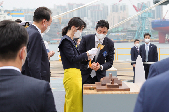 윤석열 대통령 부인 김건희 여사가 28일 울산 현대중공업에서 열린 정조대왕함 진수식에서 진수 도끼로 진수선을 자르고 있다. 진수선을 자르는 것은 아기의 탯줄을 끊는 것과 같이 새로운 배의 탄생을 의미하는 것으로 19세기 초 영국 빅토리아 여왕이 진수식을 주관한 이래 여성이 의식을 주관하는 전통이 이어지고 있다. 2022. 7. 28 박지환 기자