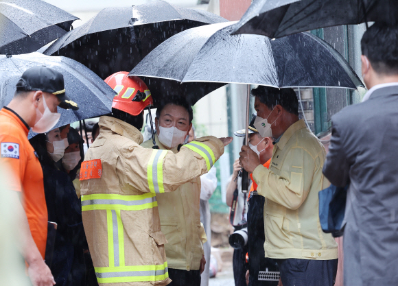 윤석열 대통령이 9일 간밤 폭우로 일가족 3명이 사망한 서울 관악구 신림동의 다세대 주택을 찾아 현장에 대한 설명을 듣고 있다. 2022. 8. 9. 박지환 기자