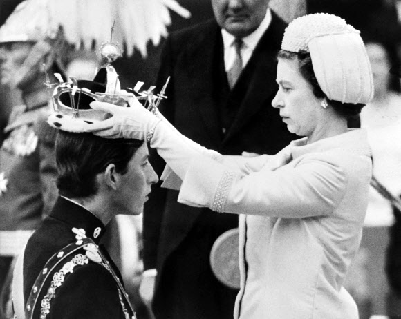 1969년 7월 1일 촬영된 사진에 엘리자베스 2세 영국 여왕이 웨일스 카나폰성에서 거행된 왕세자 책봉식에서 찰스 3세에게 왕관을 씌워주는 모습이 담겼다. AFP 연합뉴스