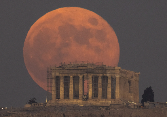 2016년 11월 8일 그리스 아테네, 고대 파르테논 신전사이로 보름달이 떠오르고 있다. (AP Photo/Petros Giannakouris)