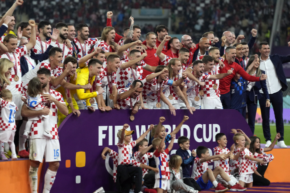크로아티아 선수들이 2022년 12월 17일 토요일 카타르 도하 칼리파 국제경기장에서 열린 크로아티아와 모로코의 월드컵 플레이오프 축구 경기가 끝나고 가족들과 함께 축하하고 있다. (AP )